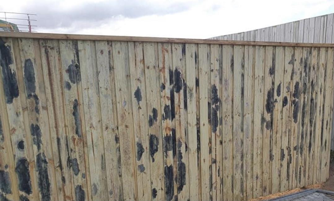 Black marks on timber fence